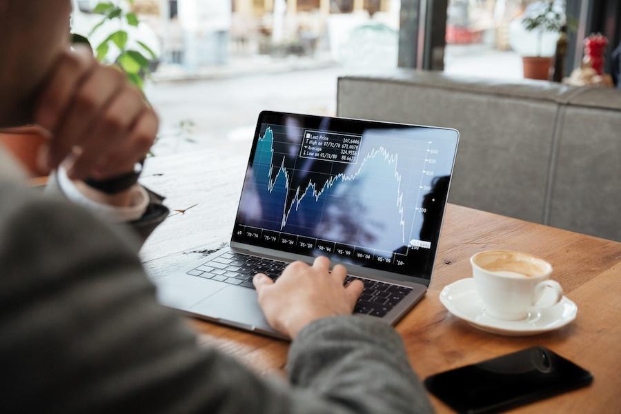 Types of trading orders: A cropped image of a businessman sitting by the table in a café and analyzing types of orders in trading Types of trading orders: A cropped image of a businessman sitting by the table in a café and analyzing types of orders in trading