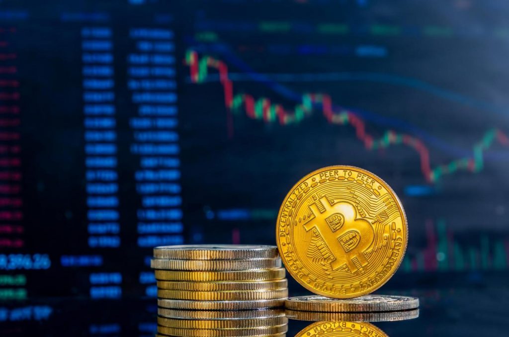 Bitcoin trading is represented with a Bitcoin coin in front of a BTC chart