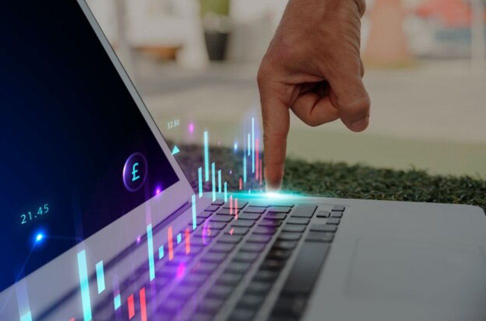 Long Position vs. Short Position: A person pressing a laptop keyboard while short trading with a price chart hologram