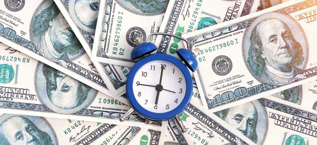 A clock on piles of dollars represents crypto futures trading hours