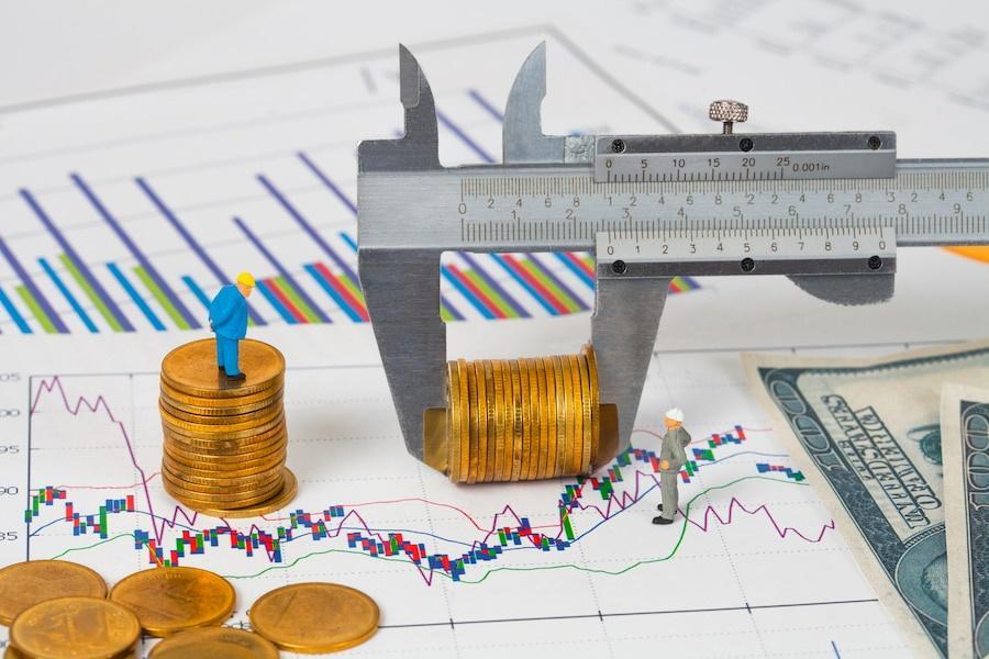 Phemex funding rates: Miniature man and vernier measuring money coin on business chart